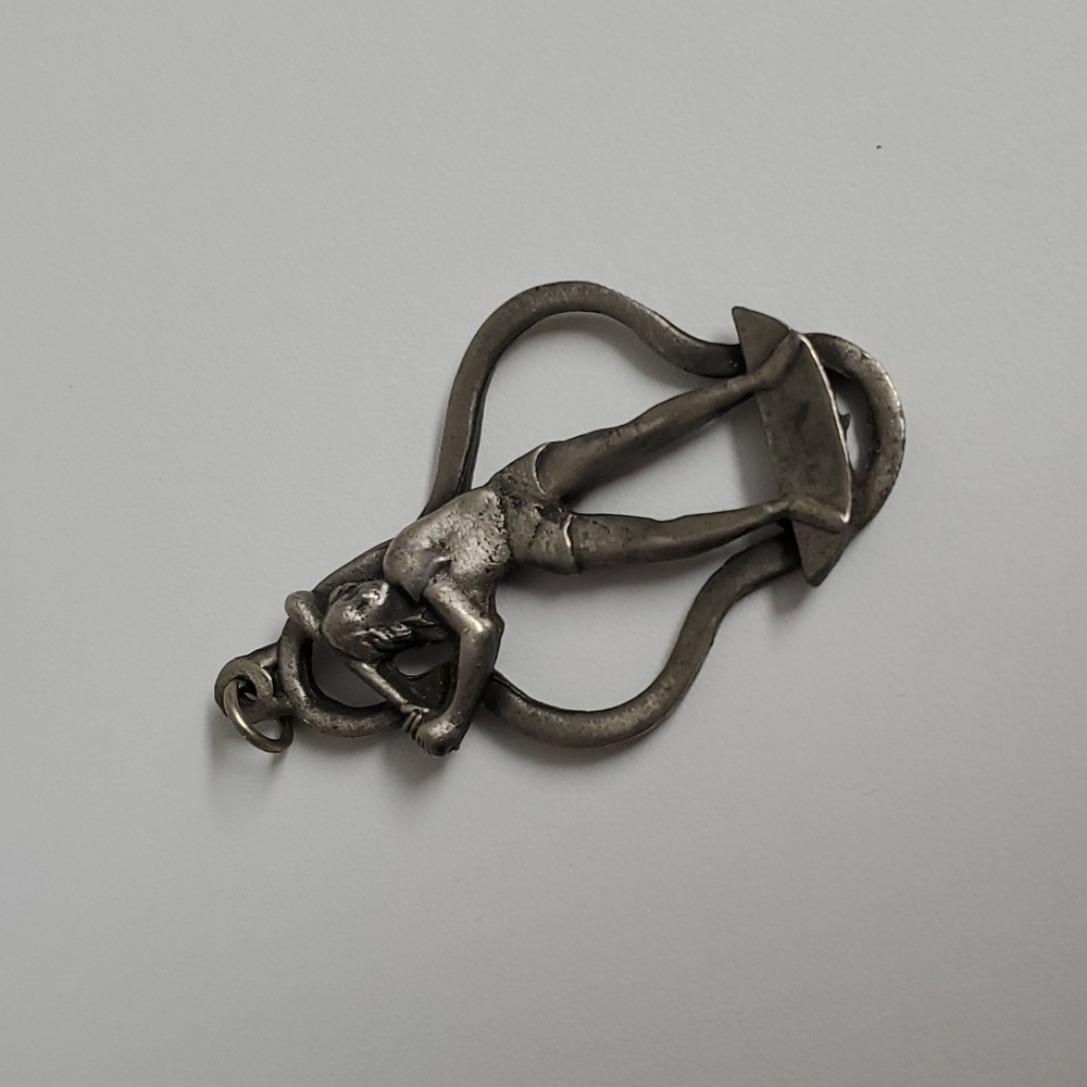 Large vintage heavy metal (seems to be pewter) girl softball player pendant